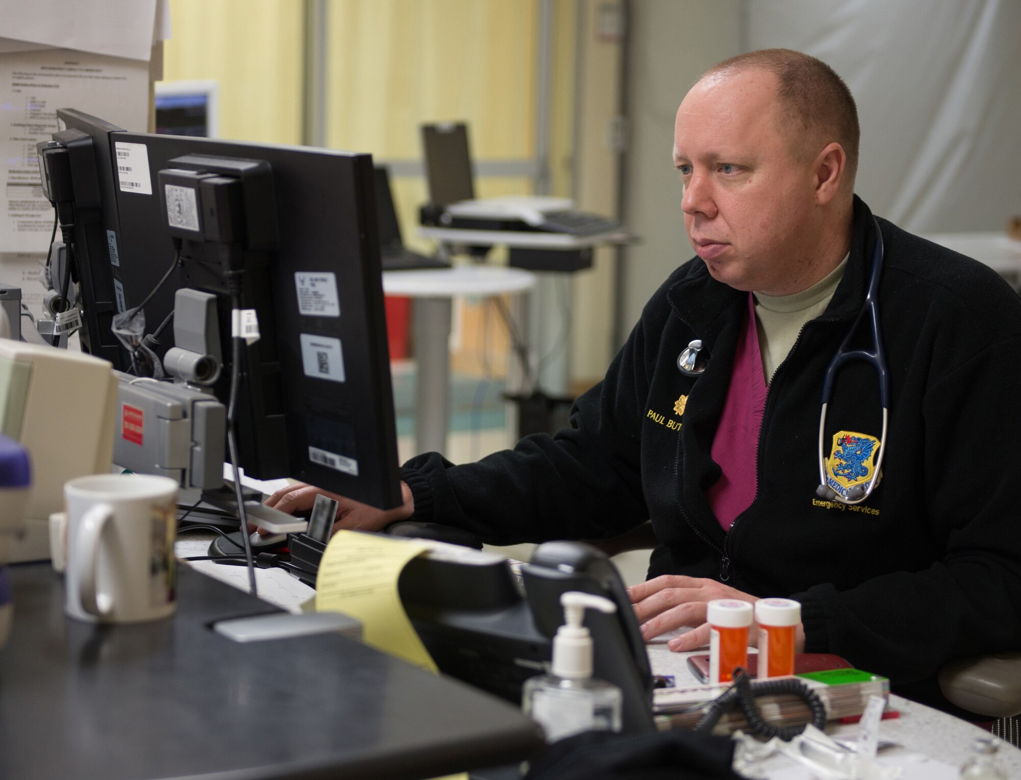 Maj. (Dr.) Paul Butts, 81st Medical Operations Squadron physician, updates patient records in the emergency services department at the Keesler Medical Center July 1, 2016, on Keesler Air Force Base, Miss. Keesler’s emergency room, which is open 24/7, sees around 2,000 patients monthly and is one of several clinics in the medical center. (U.S. Air Force photo by Marie Floyd/Released) 