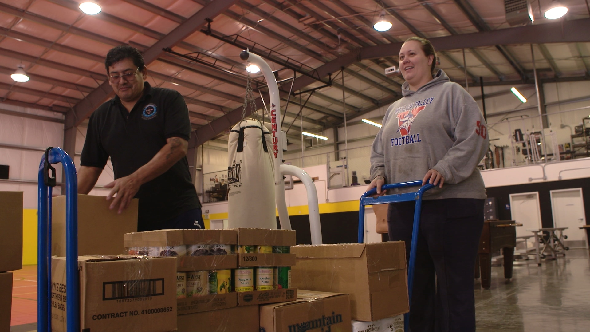 David Gibson loads boxes of food for Food Distribution Program on Indian Reservations participant Titiana Burks, at the Small Tribes of Western Washington’s food distribution site at the Shoalwater Bay Reservation.