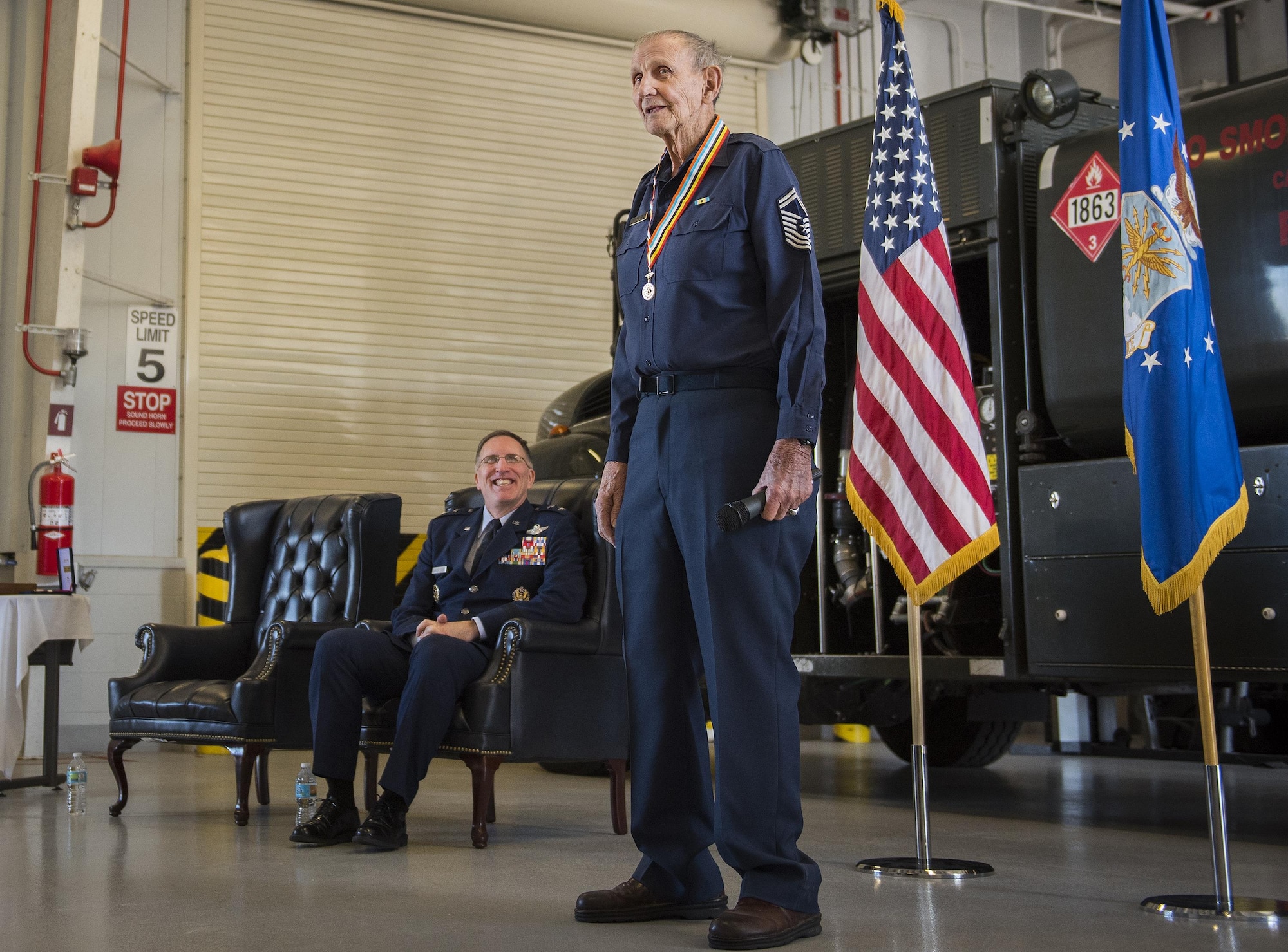 Retired Chief Master Sgt. Russell Rhodes speaks to the audience after receiving the Korean Ambassador for Peace Medal at Eglin Air Force Base, Fla., Nov. 15, 2016. The 85-year-old Rhodes requested the medal ceremony be held at the base’s fuels flight, where Rhodes was stationed during his Air Force career as a fuel truck driver. (U.S. Air Force photo/Samuel King Jr.)