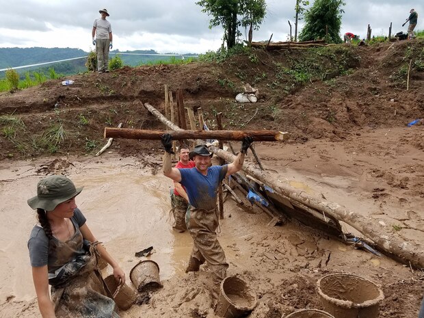 In this file photo, Maj. Aaron Pumerantz (center), a native of Simsbury, Connecticut and chief of rheumatology, William Beaumont Army Medical Center, lifts a log over his head during a Defense POW/MIA Accounting Agency (DPAA) recovery mission in Quang Binh Province, Vietnam, Aug. 14, 2016.  DPAA's mission is to provide the fullest possible accounting for our missing personnel to their families and the nation. 