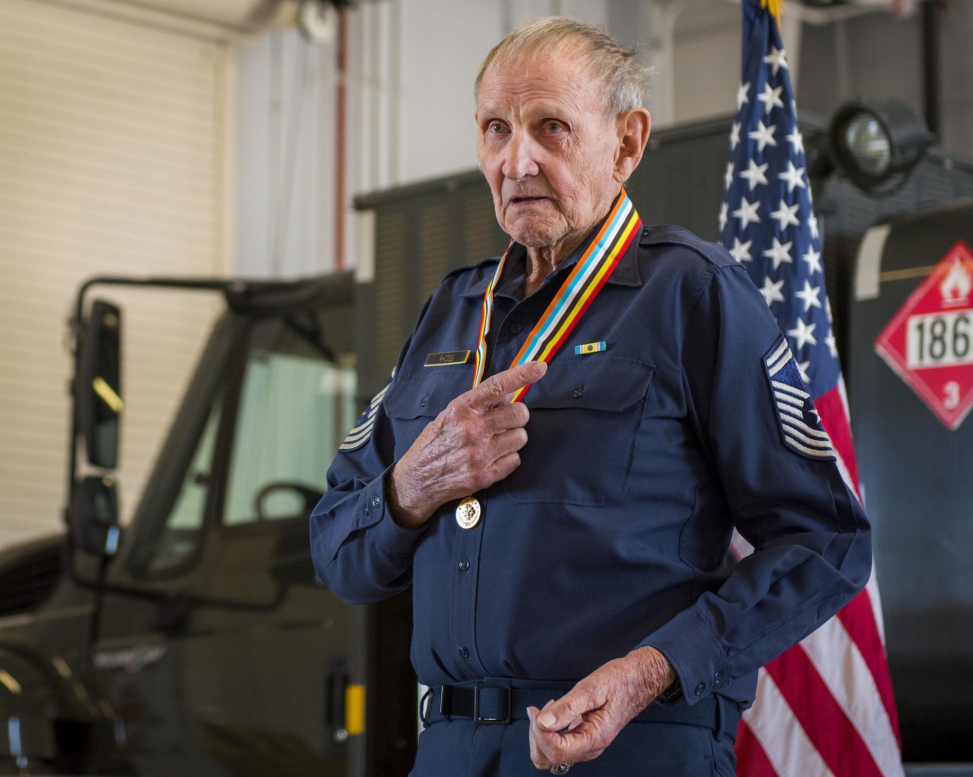 Retired Chief Master Sgt. Russell Rhodes speaks to the audience after receiving the Korean Ambassador for Peace Medal at Eglin Air Force Base, Fla., Nov. 15.  The 85-year-old Rhodes requested the medal ceremony be held at the base’s fuels flight, where Rhodes was stationed during his Air Force career as a fuel truck driver.  (U.S. Air Force photo/Samuel King Jr.)