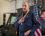 Retired Chief Master Sgt. Russell Rhodes speaks to the audience after receiving the Korean Ambassador for Peace Medal at Eglin Air Force Base, Fla., Nov. 15.  The 85-year-old Rhodes requested the medal ceremony be held at the base’s fuels flight, where Rhodes was stationed during his Air Force career as a fuel truck driver.  (U.S. Air Force photo/Samuel King Jr.)