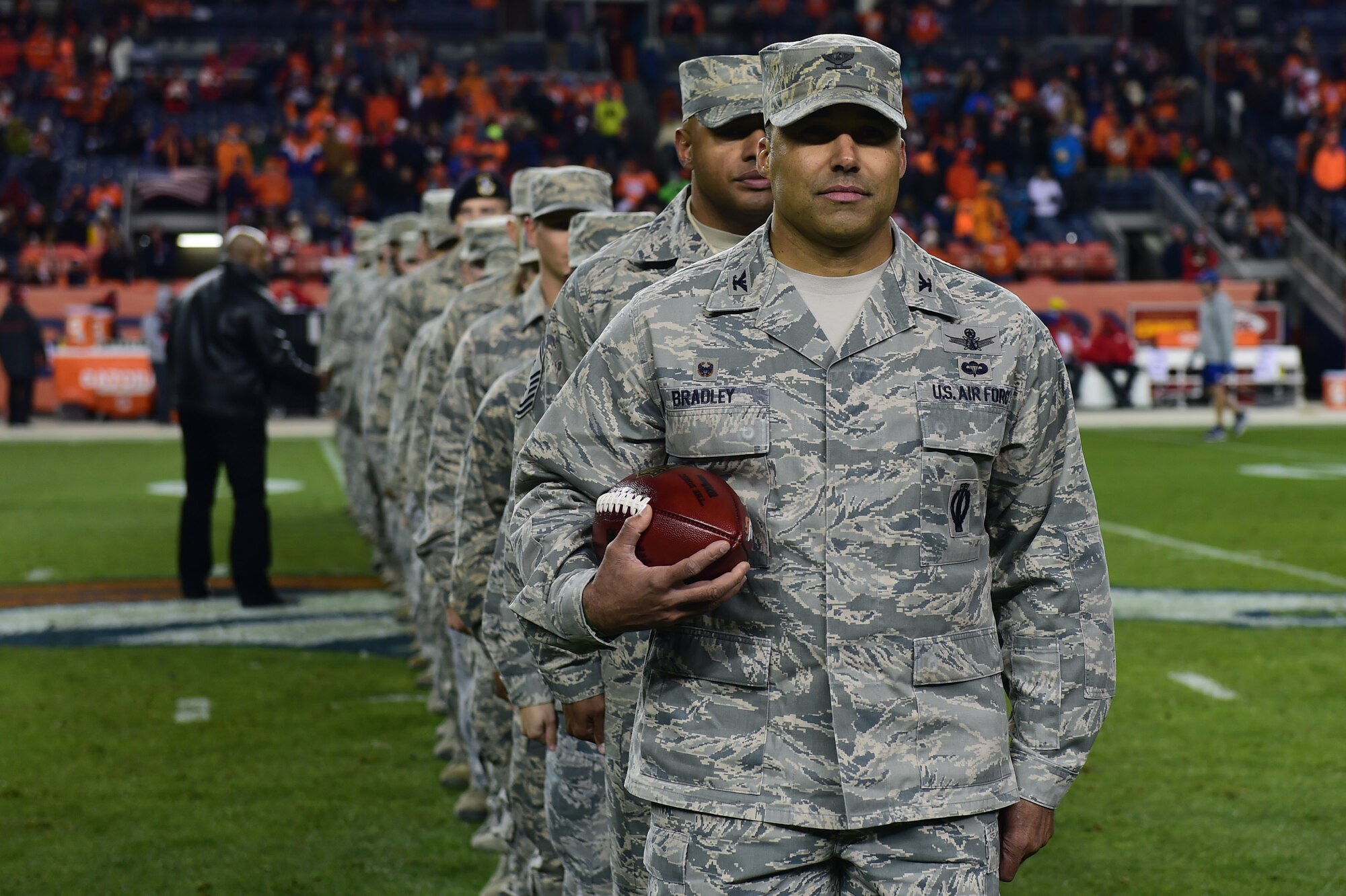 Col. Lorenzo Bradley, 460th Operations Group commander, along with other members of Team Buckley participate in a halftime ceremony Nov. 27, 2016, during a Denver Broncos Salute to Service game at Sports Authority Field at Mile High in Denver. The pregame and halftime ceremonies included representatives from all branches. (U.S. Air Force photo by Airman 1st Class Gabrielle Spradling/Released)