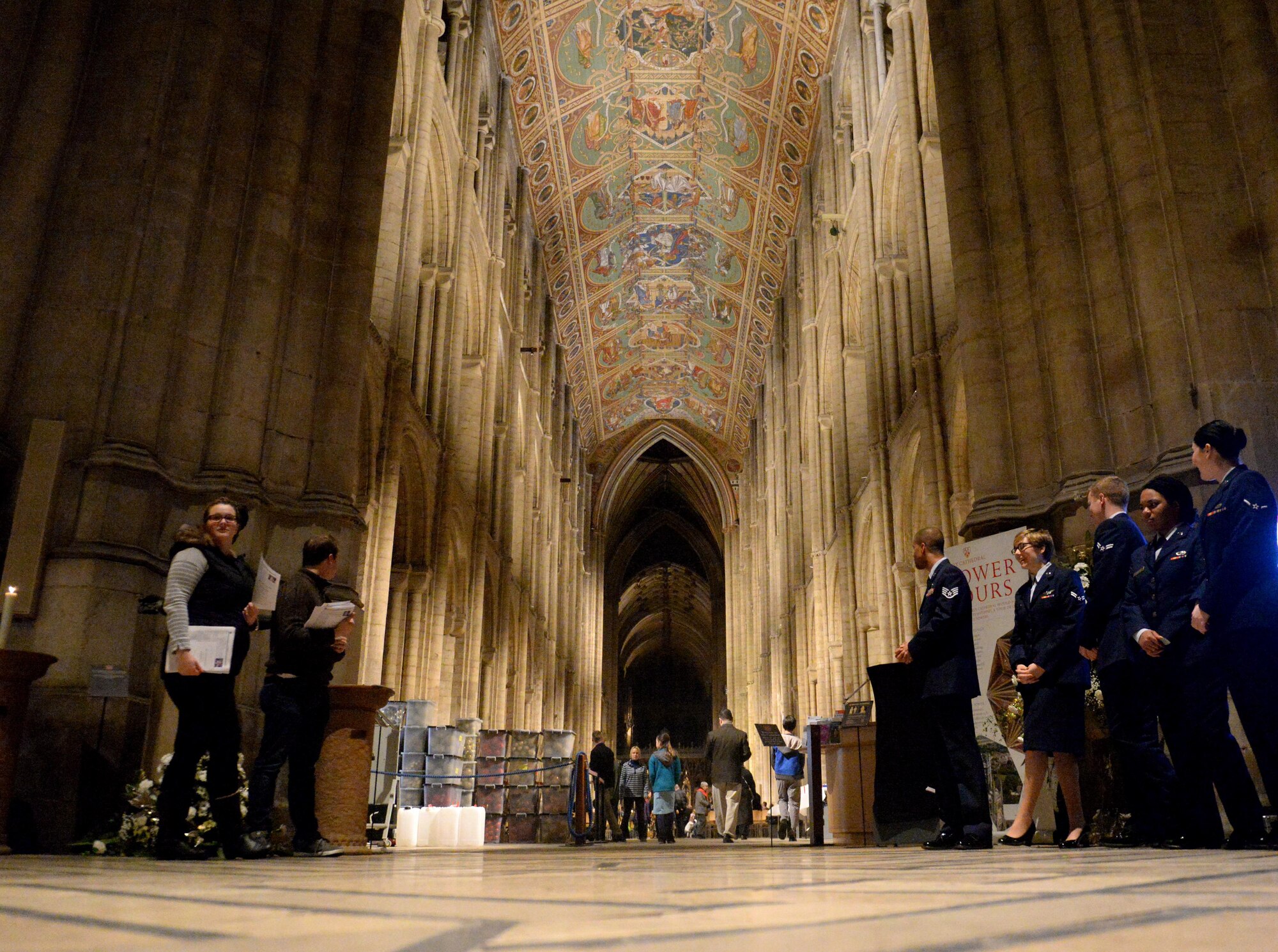 U.S. Air Force Airmen assigned to the 100th Air Refueling Wing await guests attend a Thanksgiving service Nov. 23, 2016, at Ely Cathedral in Ely, England. Volunteers from RAF Mildenhall and RAF Lakenheath helped make the service possible by seating guests, serving refreshments, participating in a joint-base choir and more. (U.S. Air Force photo by Staff Sgt. Kate Thornton)