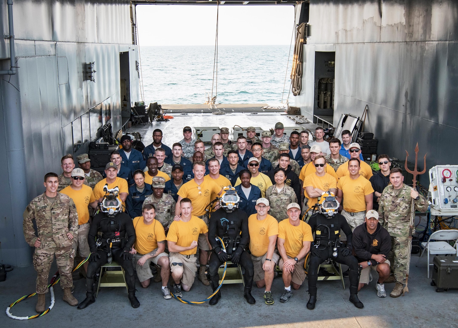 The 511th Engineer Dive Detachment from Fort Eustis, Va., and the entire crew of the MG Charles P. Gross (Logistics Support Vessel-5), pose for a group photo while anchored on the Arabian Gulf, off the coast of Kuwait Naval Base, Nov. 18, 2016. Soldiers from the dive unit utilized the vessel to conduct a two-week diving exercise, Operation Deep Blue, enhancing the team’s overall readiness and ability to support U.S. Army Central missions. (U.S. Army photo by Sgt. Angela Lorden)