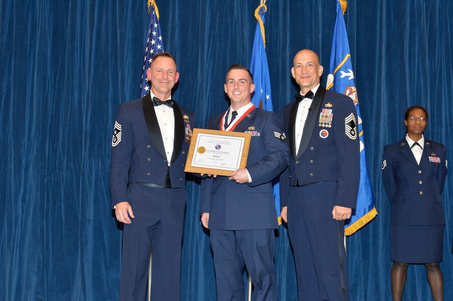 Senior Airman Matthew Choiniere receives the Distinguished Graduate Award for Airman leadership school class 17-1 from Chief Master Sgt. David Eddy, Chief Master Sgt. of the Michigan Air National Guard, and Chief Master Sgt. Edward Walden, Sr., Commandant of the Paul H. Lankford Enlisted PME Center, here, Nov. 15, 2016, at the I. G. Brown Training and Education Center. The distinguished graduate award is presented to students in the top 10 percent of the class. (U.S. Air National Guard photo by Master Sgt. Jerry D. Harlan/Released)