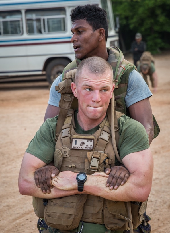 A Sri Lankan marine “buddy” drags Marine Corps 1st Lt. Robert Simpson, a platoon commander with Alpha Company, Battalion Landing Team 1st Battalion, 4th Marines, 11th Marine Expeditionary Unit, during physical training as part of a Theater Security Cooperation engagement exercise at Sri Lanka Naval Base in Trincomalee, Sri Lanka, Nov. 25, 2016. American and Sri Lankan Marines taught each other different styles of military physical fitness. The 11th MEU, part of the Makin Island Amphibious Ready Group, is operating in the U.S. 7th Fleet’s area of responsibility in support of security and stability in the Indo-Asia-Pacific region. Marine Corps photo by Lance Cpl. Zachery Laning