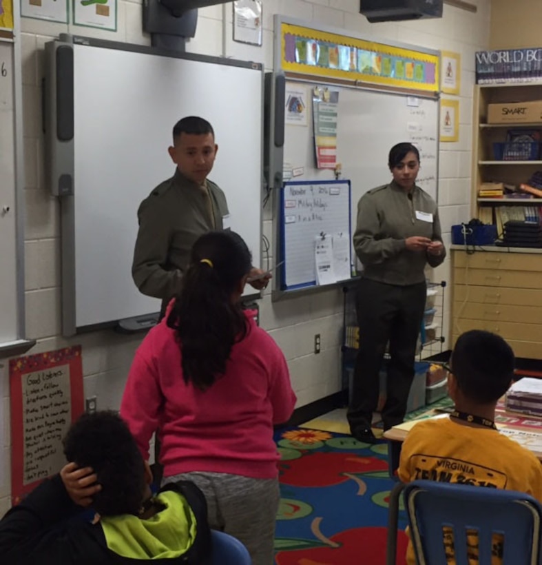 On 9 November, sixteen Marines visited Triangle Elementary School in Prince William County outside the main gate of Quantico as part of the Adopt-A-School program. Once the Marines arrived at the school, they greeted students and helped them with their morning routine.  During the day, Marines participated in activities in all grade levels at the school.  Marines demonstrated how to do a proper push up as part of wellness stations in PE, helped Head Start students open their milk for breakfast, read to kindergartners, and presented good behavior certificates to 3rd graders.   

Triangle Elementary is just one of the schools that benefit from the program, which sends Marines to public schools to assist teachers and students and ultimately have a positive impact on the lives of students.  
