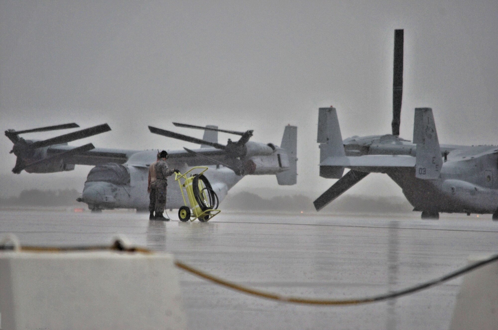 An Airman assigned to the Air Mobility Command moves a fire extinguisher prior to an aircraft taxiing during a Coronet mission at Morón Air Base, Spain, Nov. 10, 2016. This mission occurs semiannually and supports a major Air Expeditionary Force fighter aircraft swap-out between the U.S. and the Middle East. (U.S. Air Force photo by Capt. Jose A. Quintanilla)