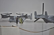 An Airman assigned to the Air Mobility Command moves a fire extinguisher prior to an aircraft taxiing during a Coronet mission at Morón Air Base, Spain, Nov. 10, 2016. This mission occurs semiannually and supports a major Air Expeditionary Force fighter aircraft swap-out between the U.S. and the Middle East. (U.S. Air Force photo by Capt. Jose A. Quintanilla)