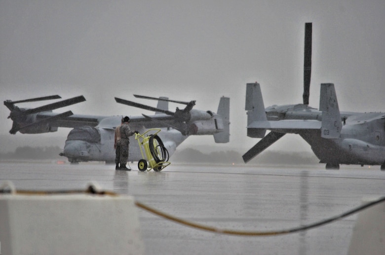 An Airman assigned to the Air Mobility Command moves a fire extinguisher prior to an aircraft taxiing during a Coronet mission at Morón Air Base, Spain, Nov. 10, 2016. This mission occurs semiannually and supports a major Air Expeditionary Force fighter aircraft swap-out between the U.S. and the Middle East. (U.S. Air Force photo by Capt. Jose A. Quintanilla)
