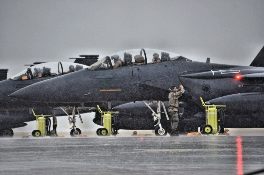 An Airman assigned to Air Combat Command marshals an F-15 Strike Eagle aircraft during a Coronet mission at Morón Air Base, Spain, Nov. 10, 2016. This mission will last almost 60 days and is a major Air Expeditionary Force fighter aircraft swap-out between the U.S. and the Middle East. (U.S. Air Force photo by Capt. Jose A. Quintanilla)