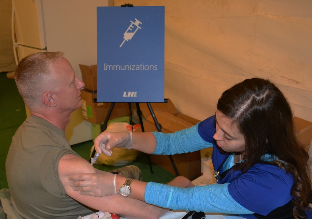 Brig. Gen. David Elwell, 311th Expeditionary Sustainment Command commanding general, is injected with an influenza vaccine at the Fort Irwin National Training Center November 19, during a joint Field Training Exercise, while a MUTA 8 four-day battle assembly was conducted, where collective training events as well as individual readiness focused on medical readiness and firearms qualification. Combat readiness remains a high priority for U.S. Army Reserve units throughout the Army.