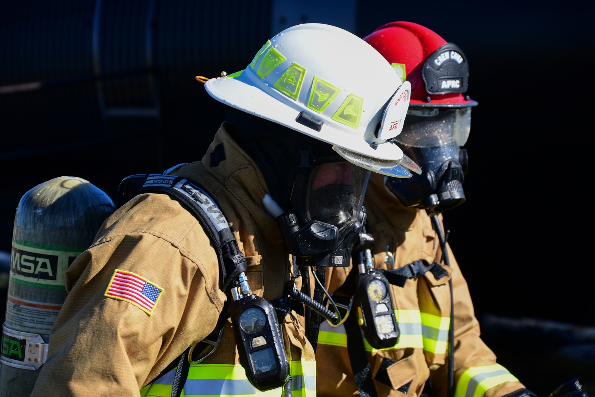 U.S Air Force Col. William Rock, 307th Mission Support Group commander, gets debriefed after a live fire exercise by a member of the 307th Civil Engineer Squadron Fireman on November 19, 2016 at Barksdale Air Force Base, La. Many of the members just received new bunker gear and got to try it out for the first time. (U.S. Air Force photo by Master Sgt. Laura Siebert/ Released)