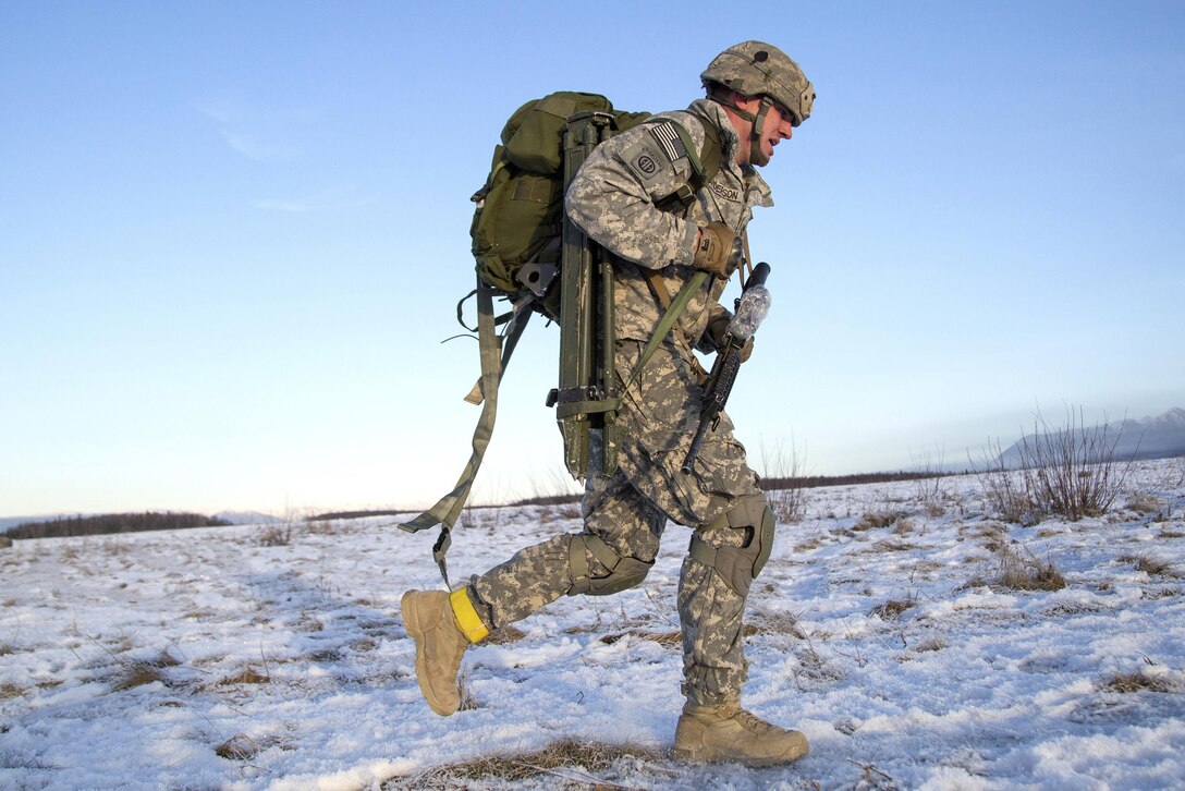 Army Sgt. 1st Class Kody Anderson rushes to the rally point while participating in airborne and live-fire training at Joint Base Elmendorf-Richardson, Alaska, Nov. 22, 2016. Anderson is assigned to the 25th Infantry Division’s 2nd Battalion, 377th Parachute Field Artillery Regiment, 4th Infantry Brigade Combat Team (Airborne), Alaska. Air Force photo by Alejandro Pena