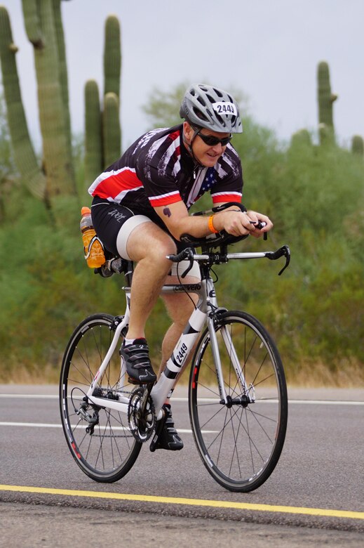 1st Sgt. Mitter of the 315th Engineer Battalion, 301st Maneuver Enhancement Brigade, rides during the cycling portion of the Ironman in Tempe, Ariz. on November 20, 2016. The Ironman is a physically demanding triathlon event consisting of a 2.4 mile swim, 112 mile bicycle race and a 26.2 mile run.