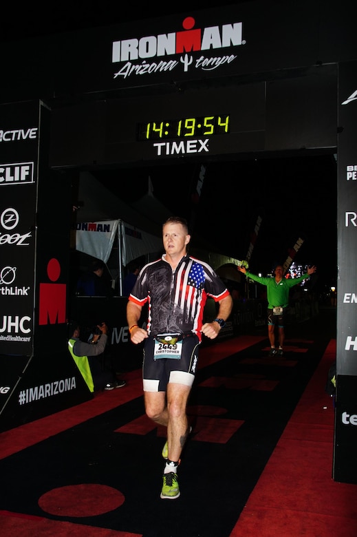 1st Sgt. Mitter of the 315th Engineer Battalion, 301st Maneuver Enhancement Brigade, crosses the finish line of the Ironman in Tempe, Ariz. on November 20, 2016. The Ironman is a physically demanding triathlon event consisting of a 2.4 mile swim, 112 mile bicycle race and a 26.2 mile run.