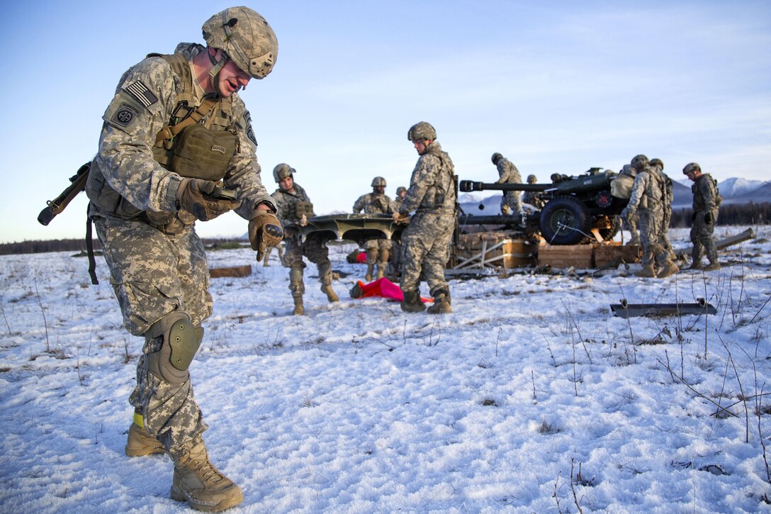 Army Sgt. 1st Class Kody Anderson indicates where to place an artillery base plate while participating in airborne and live-fire training at Joint Base Elmendorf-Richardson, Alaska, Nov. 22, 2016. Anderson is assigned to the 25th Infantry Division’s 2nd Battalion, 377th Parachute Field Artillery Regiment, 4th Infantry Brigade Combat Team (Airborne), Alaska. Air Force photo by Alejandro Pena