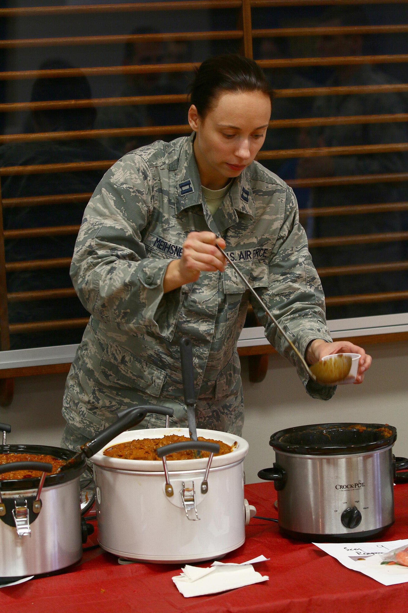 Capt. Ashley Meihsner, 64th Intelligence Squadron, takes a sample of chili for taste and texture while judging the 2016 655th Intelligence, Surveillance and Reconnaissance Group Chili Cook-Off at the USO here Nov. 19, 2016. The four categories were: best overall, spiciest, white chili and most creative. Capt. James Spindler, 64th IS, was selected as the overall winner of the contest. (U.S. Air Force photo /Tech. Sgt. Patrick O’Reilly)