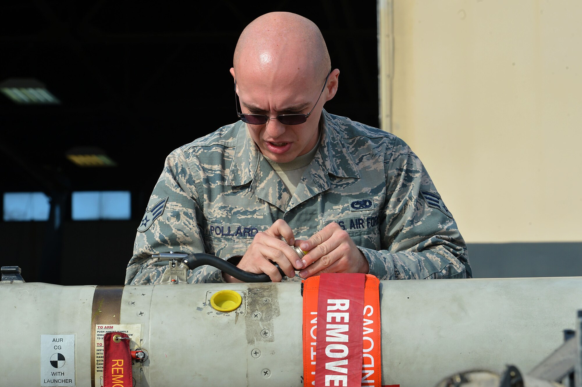 U.S. Air Force Senior Airman Benjamin Pollard, 20th Aircraft Maintenance Squadron load crew member, inspects an inert 2,000 pound guided bomb unit, during a Load Crew of the Quarter competition at Shaw Air Force Base, S.C., Nov. 23, 2016. During the competition, crews loaded three different munitions onto an F-16CM Fighting Falcon. (U.S. Air Force photo by Airman 1st Class Christopher Maldonado)