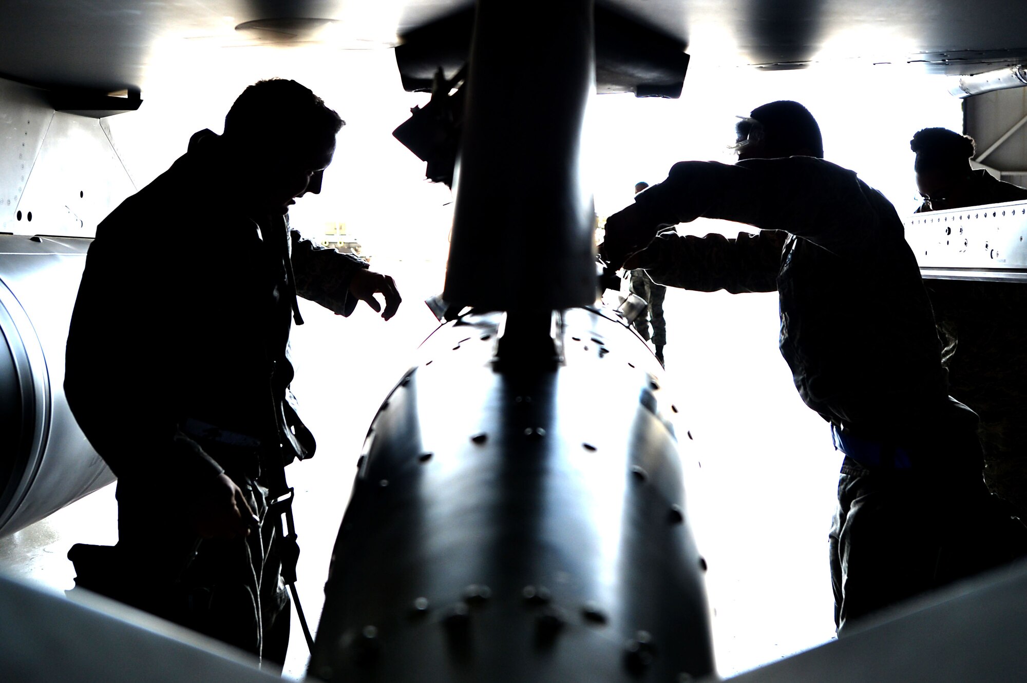 U.S. Airmen assigned to the 20th Aircraft Maintenance Squadron position a munition onto an F-16CM Fighting Falcon during a Load Crew of the Quarter competition at Shaw Air Force Base, S.C., Nov. 23, 2016. Load crew competitions require crew members to work as a team to successfully complete all required tasks within an allotted time. (U.S. Air Force photo by Airman 1st Class Christopher Maldonado)