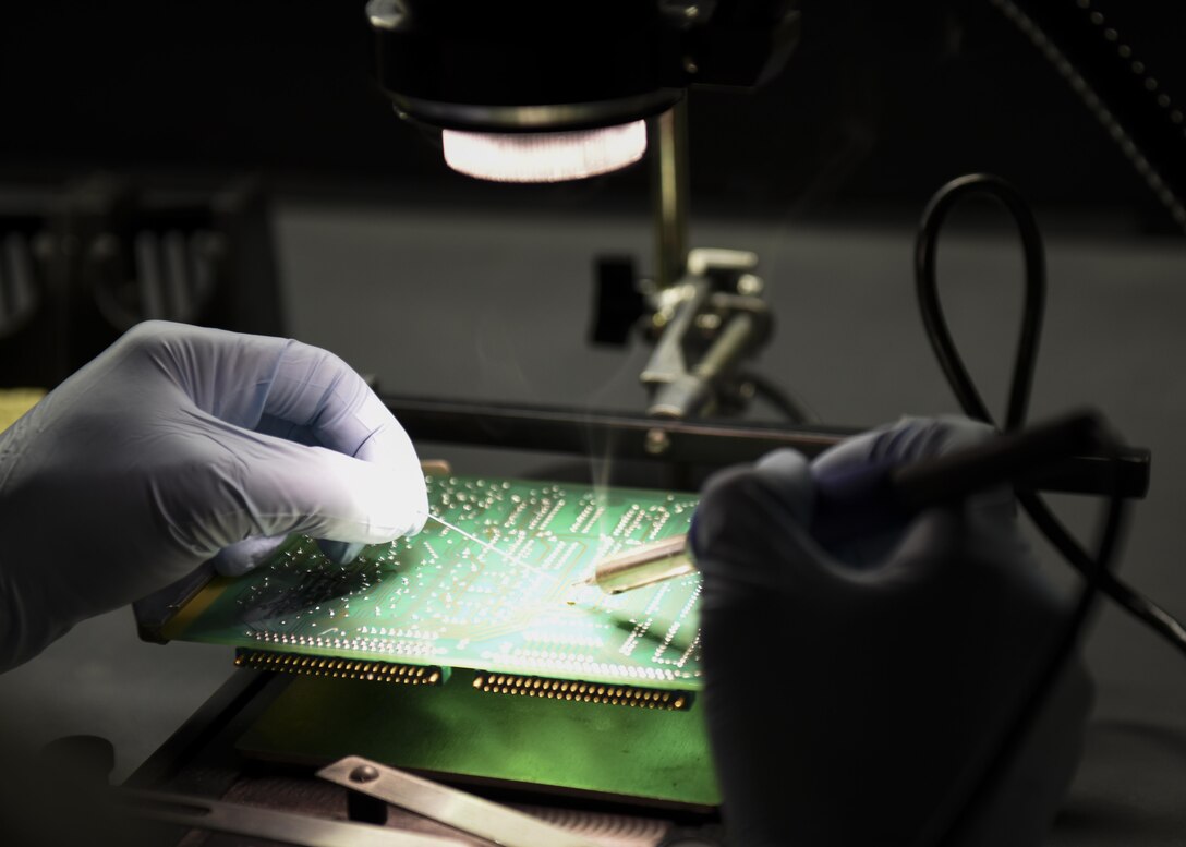 U.S. Air Force Staff Sgt. James Lott, an Air Force Repair Enhancement Program circuit card technician assigned to the 509th Maintenance Group, works at a soldering station to fix a circuit card at Whiteman Air Force Base, Mo., Nov. 17, 2016. A heater is located under the circuit card to help solder joints and reduce the chance of thermal shock on components.