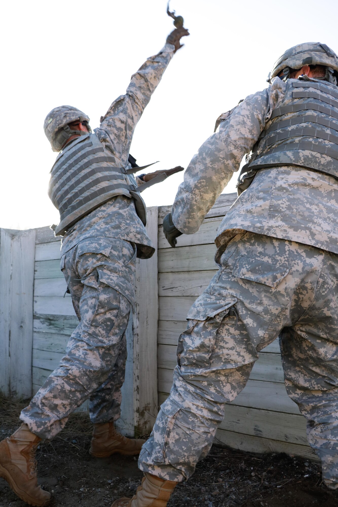 U.S. Army Sgt. Miguel Bracer, 7th Transportation Brigade (Expeditionary) cargo specialist, throws a M228 grenade during qualification training at Fort Pickett, Va., Nov. 17, 2016. The M228 grenade fuze is equipped with a steel safety pin, pull pin and a safety clip. (U.S. Army photo by Spc. Wilmarys Roman Rivera)