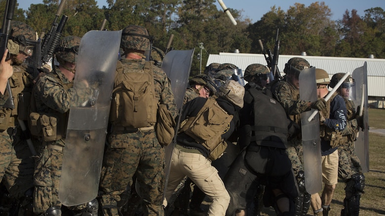 Marines clash with opposing role-players during the final exercise of the non-lethal weapons training course at Camp Lejeune N.C., Nov. 18, 2016. Marines with 3rd Battalion, 6th Marine Regiment, 2nd Marine Division, participated in the training in preparation for their deployment with the 24th Marine Expeditionary Unit. 