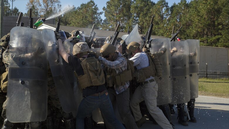 Marines use mock OC spray, also known as pepper spray, on role-players during the final exercise of the non-lethal weapons training course at Camp Lejeune N.C., Nov. 18, 2016. Marines with 3rd Battalion, 6th Marine Regiment, 2nd Marine Division, participated in the training in preparation for their deployment with the 24th Marine Expeditionary Unit. 