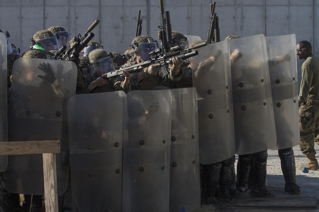 Marines assault over the shield line during the final exercise of the non-lethal weapons training course at Camp Lejeune N.C., Nov. 18, 2016. Marines with 3rd Battalion, 6th Marine Regiment, Battalion Landing Team with the 24th Marine Expeditionary Unit participated in the training in preparation for their upcoming deployment. (U.S. Marine Corps photo by Lance Cpl. Victoria Ross)