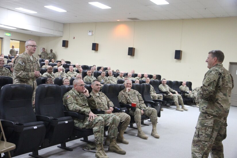 Army Reserve Maj. Gen. Mark W. Palzer (right), commanding general of the 79th Sustainment Support Command, answers a question from Col. John J. Waldron, Jr. (left), chief of staff of the 451st Expeditionary Sustainment command, during a town hall meeting held Nov. 28, 2016 at Camp Arifjan, Kuwait.