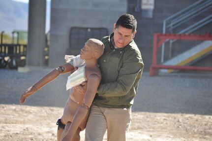 Sgt. Pedro Lujan, Company B, 410th Civil Affairs Battalion, U.S. Army Reserve, carries a simulated casualty to safety during close-quarters combat training at McGregor Range, N.M., Nov. 19, 2016.