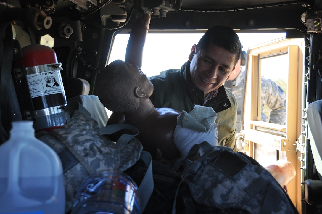 Sgt. Pedro Lujan, Company B, 410th Civil Affairs Battalion, U.S. Army Reserve, places a simulated casualty in a Humvee during close-quarters combat training at McGregor Range, N.M., Nov. 19, 2016.