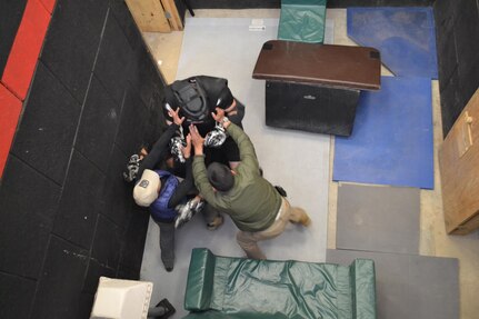 Sgts. Pedro Lujan, right, and Miriana Taylor, left, assigned to Company B, 410th Civil Affairs Battalion, U.S. Army Reserve, take on Pvt. Juan Garcia, assigned to 1st Battalion, 35th Armor Regiment, 2nd Brigade Combat Team, 1st Armored Division, who was posing an a hostile intruder during close-quarters combat training at McGregor Range, N.M., Nov. 19, 2016.