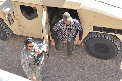 Sgt. Cesar Medina, right, assigned to Company B, 410th Civil Affairs Battalion, U.S. Army Reserve, arrives at a close-quarters combat training scenario at McGregor Range, N.M., Nov. 19, 2016. First Lt. Colby Richardson, in uniform, team chief and officer in charge of the range, stands right.