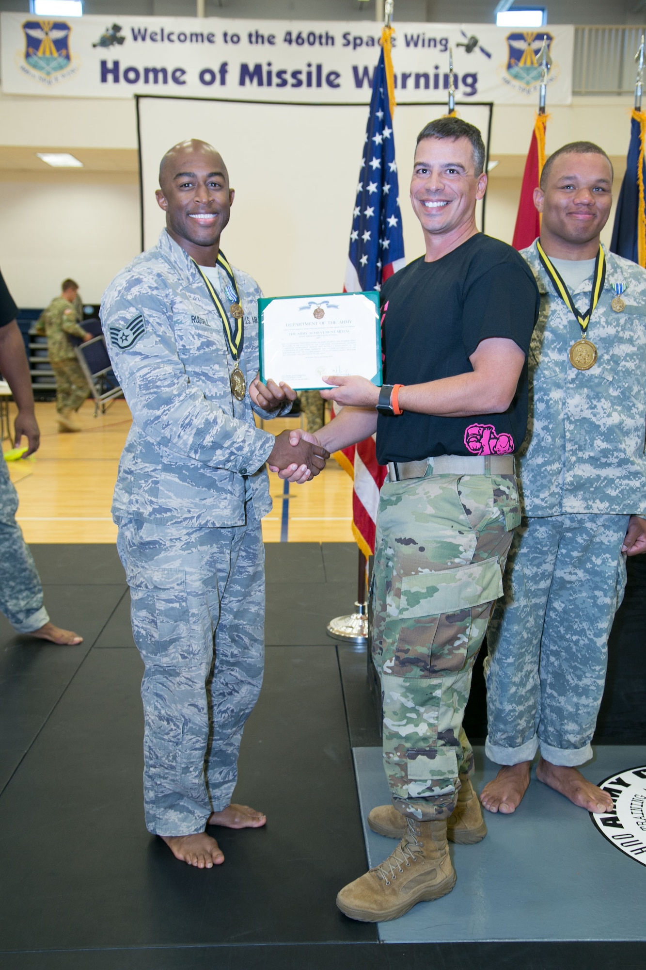 Staff Sgt. Brandon Russell, Air Reserve Personnel Center, is awarded an Army Achievement Medal during a Combatives Tournament at Buckley Air Force Base, Colo., Oct. 26. Russell defeated more than 15 Soldiers to place first in his division. (Courtesy photo by Annabel Flores)