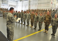 Dozens of recently promoted 919th Special Operations Wing master sergeants stand at attention as Chief Master Sgt. Brian Bischoff, the wing's command chief, reads the Senior NCO Charge during their induction ceremony at Duke Field, Fla., Nov. 6, 2016.  The event, which inducts Airmen into the top tier of the enlisted force, capped off the three-day November unit training assembly's commander's call. (U.S. Air Force photo/Dan Neely)   