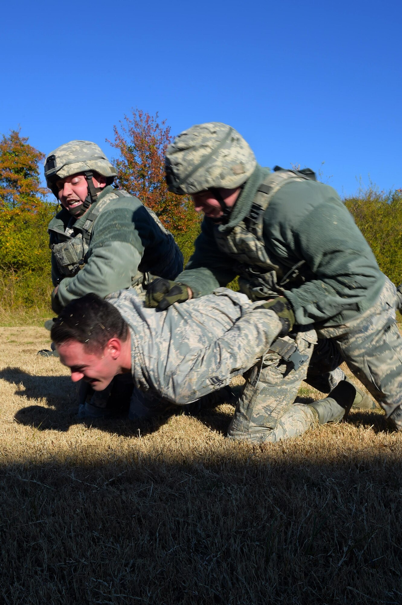 Members of the 633rd Security Forces Squadron detain an individual during training at Joint Base Langley-Eustis, Va., Nov. 21, 2016. The training was designed to teach 633rd SFS members how to protect an F-22 Raptor on display. (U.S. Air Force photo by Senior Airman Kimberly Nagle)