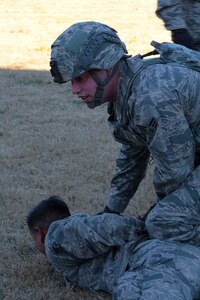U.S. Air Force Senior Airman Timothy Hobson, 633rd Security Forces Squadron response force leader, apprehends an individual during training at Joint Base Langley-Eustis, Va., Nov. 21, 2016. The 633rd SFS members trained on F-22 Raptor cordon security measures. (U.S. Air Force photo by Senior Airman Kimberly Nagle)