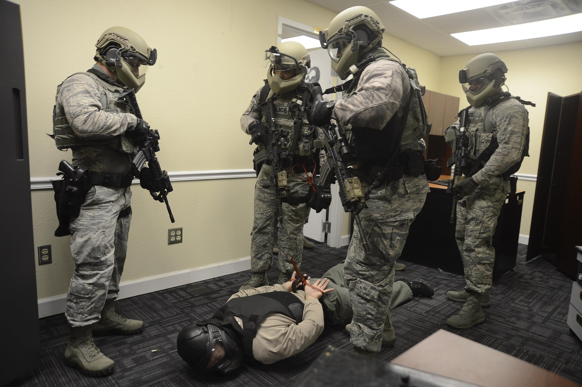 Emergency services team (EST) members assigned to the 6th Security Forces Squadron capture a decoy suspect while clearing a building during an immersion, Nov. 21, 2016 at MacDill Air Force Base, Fla. The EST is a highly-trained and highly-skilled tactical team capable of mitigating high risk incidents that could potentially arise. (U.S. Air Force photo by Senior Airman Jenay Randolph)