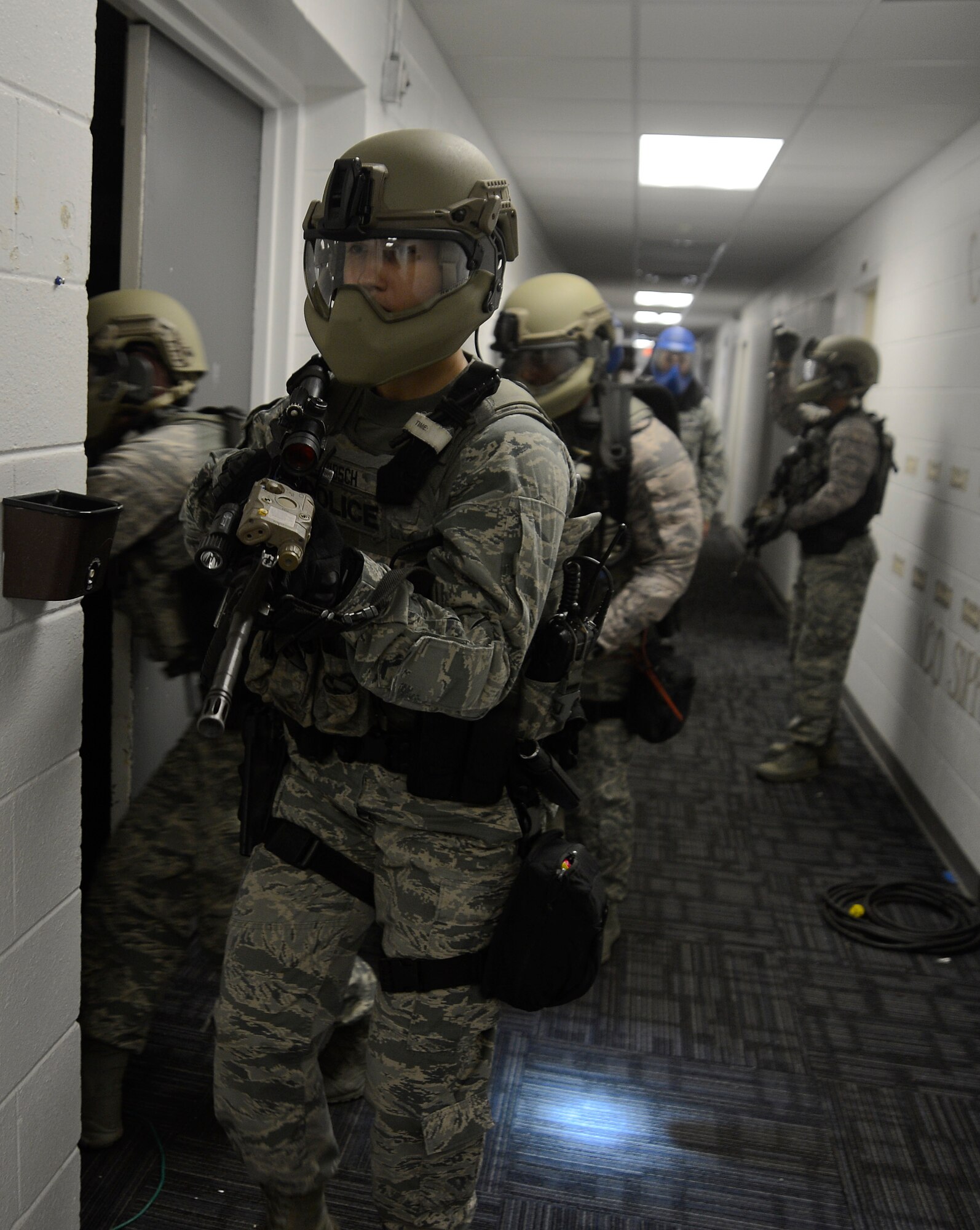 Emergency services team (EST) members assigned to the 6th Security Forces Squadron demonstrate how to properly clear a building during an immersion with leadership from the 6th Air Mobility Wing, Nov. 21, 2016 at MacDill Air Force Base, Fla. The EST members are highly-trained and highly-skilled tactical team capable of mitigating high-risk incidents that could potentially arise. (U.S. Air Force photo by Senior Airman Jenay Randolph)