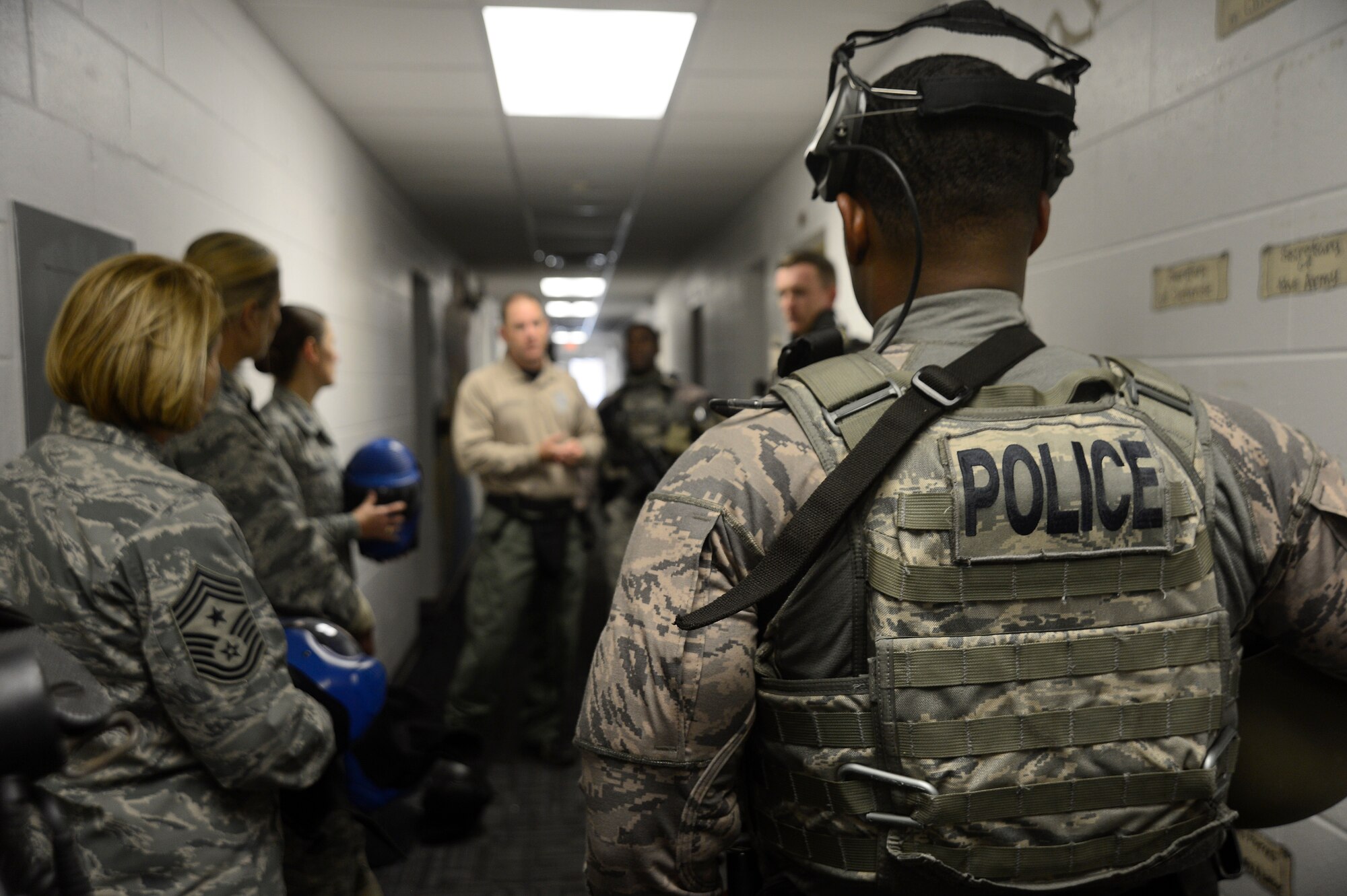 Officer Jason Atkinson, duty title assigned to the 6th Security Forces Squadron, briefs 6th Air Mobility Wing leadership on the training requirements and daily operations for emergency services team (EST) members during an immersion, Nov. 21, 2016. The EST functions are similar to civilian police departments Special Weapons and Tactics Team. (U.S. Air Force photo by Senior Airman Jenay Randolph)