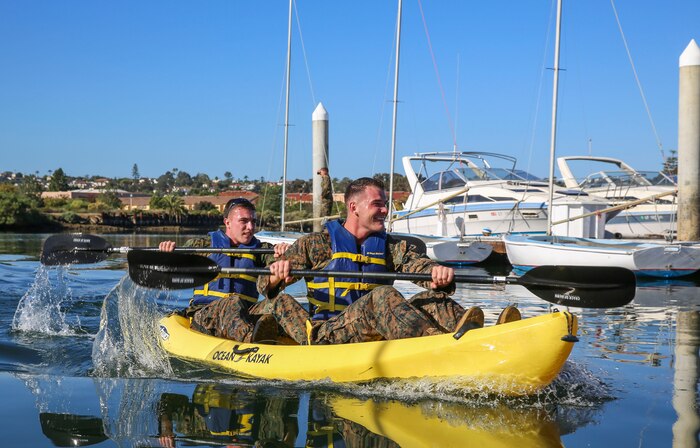 Marines of Headquarters and Service Battalion compete in a kayak race during the Atlas Games at Marine Corps Recruit Depot San Diego, Nov. 22. Teams of four raced in relays as part of the third event in the competition. The Atlas Games consisted of pull-ups, a three-mile run, tire flips, a simulated medical evacuation and a tug-of-war competition at the end of the games.