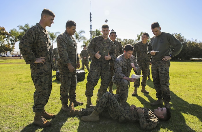 Marines of Headquarters and Service Battalion conduct a simulated medical evacuation during the Atlas Games at Marine Corps Recruit Depot San Diego, Nov. 22. The Atlas Games consisted of pull-ups, a three-mile run, tire flips, a simulated medical evacuation and a tug-of-war competition at the end of the games. Various units of the battalion competed for a 72-hour liberty period.