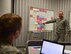 The 932nd Airlift Wing force development working group, under 22nd Air Force, and the Air Force Reserve Command, held a professional development planning session on November 15, 2016.  Two teams with enlisted leaders from public affairs, history, executive office, education, and other wing areas met to discuss first term Airman's programs of development and strategic plan for the upcoming calendar year in 2017.  Various courses will be offered in the new year that are designed to promote personal and professional growth for Air Force Reserve Command members at the Scott Air Force Base unit.  Tech. Sgt. James Hollenkamp points out a possible course of action for what could happen on day two of the future event.  (U.S. Air Force photo by Christopher Parr)