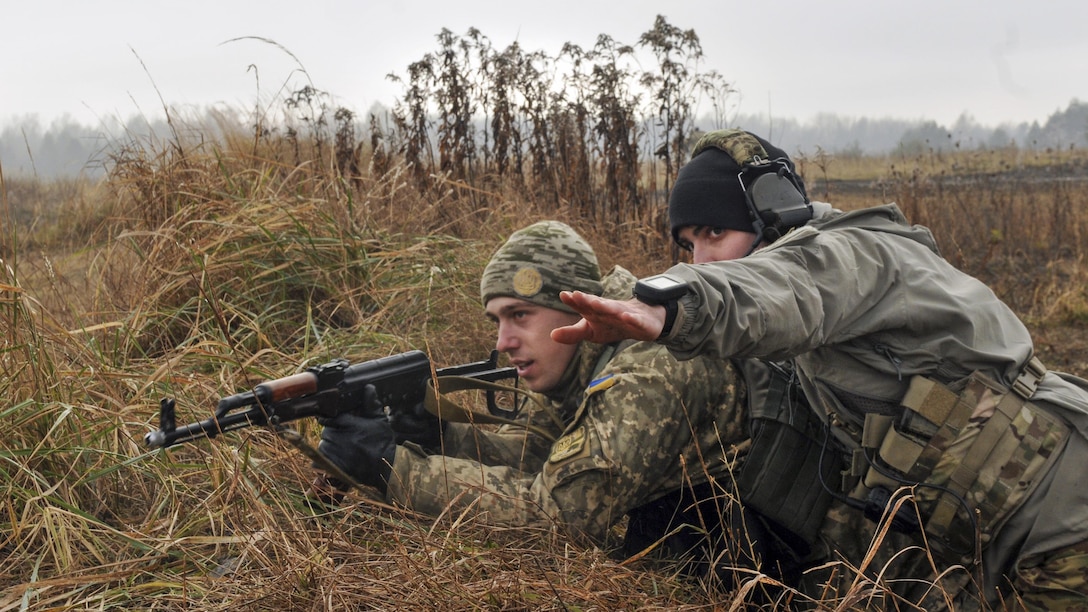 <strong>Photo of the Day: Nov. 30, 2016</strong><br/><br />Army Sgt. Christopher Marinucci points to an objective during a training exercise with Ukrainian soldiers at the International Peacekeeping and Security Center in Yavoirv, Ukraine, Nov. 26, 2016. Marinucci is an assistant team leader assigned to the 3rd Infantry Division's 6th Squadron, 8th Cavalry Regiment, 2nd Infantry Brigade Combat Team. The unit's soldiers are training Ukrainian land forces to increase their capacity for self-defense. Army photo by Staff Sgt. Elizabeth Tarr<br/><br /><a href="http://www.defense.gov/Media/Photo-Gallery?igcategory=Photo%20of%20the%20Day"> Click here to see more Photos of the Day. </a>