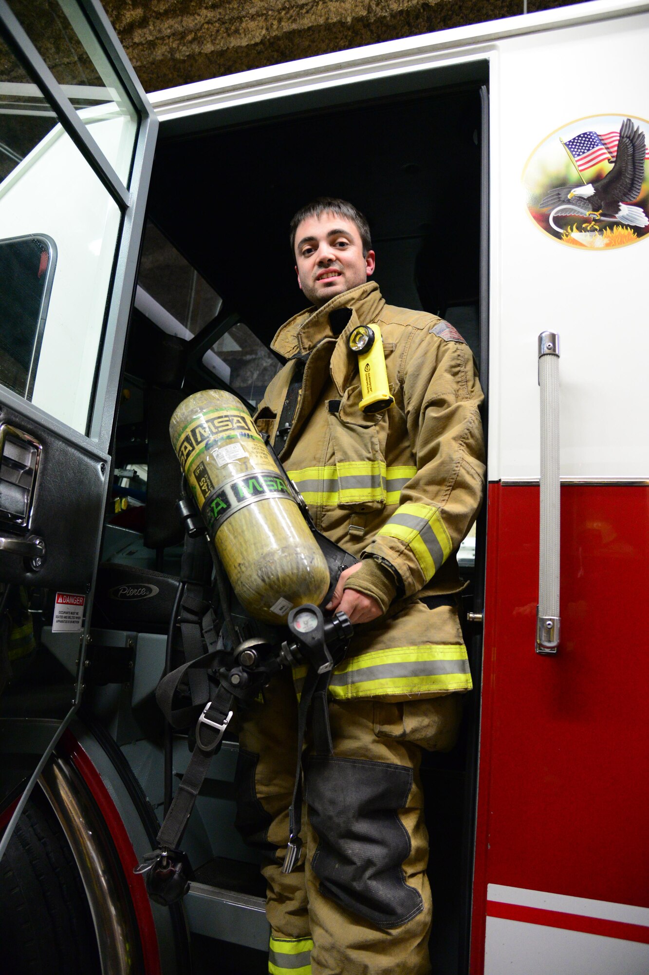 1st Lt. Anthony Perkins, 490th Missile Squadron intercontinental ballistic missile combat crew commander, poses for a photo in his firefighter gear Nov. 8, 2016, at Great Falls Gore Hill Volunteer Fire Department, Great Falls, Mont. Perkins recently received the Military Outstanding Volunteer Service Medal, which is awarded to members of the Armed Forces who perform outstanding volunteer community service that has a direct impact on the wellness of the community. (U.S. Air Force photo/Airman 1st Class Magen M. Reeves)