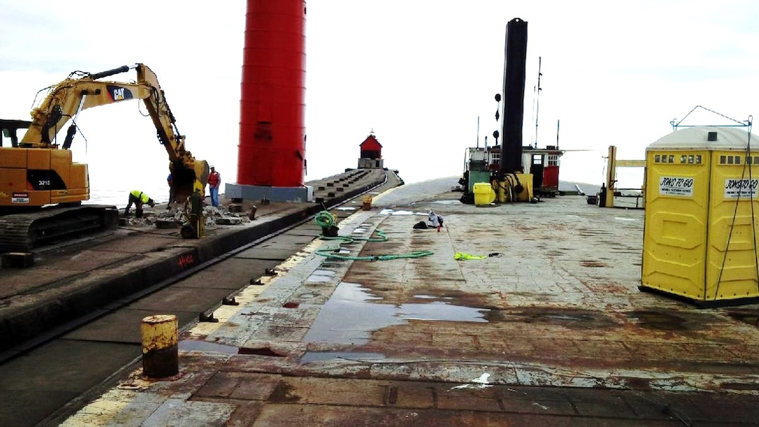 Crews work on removing Grand Haven south pier’s concrete cap. Approximately 100 feet of concrete cap has been removed to date, work has been halted for the season due to weather and will resume in the spring. (U.S. Army Photo)