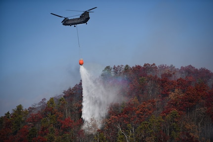 Tennessee is among a handful of states where National Guard members are involved in batting wildfires. Among others is South Carolina. In this photo, a South Carolina Army National Guard CH-47 Chinook heavy-lift cargo helicopter and a UH-60L Black Hawk medium-lift utility helicopter from 59th Aviation Troop Command and crews support the South Carolina Forestry Commission contain a remote fire near Table Rock, Pickens County, South Carolina, Nov. 24, 2016.