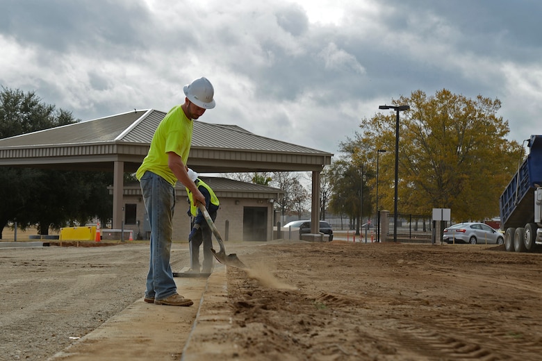 Hal Knopf, contracted construction worker, shovels dirt to keep the pavement clean at Shaw Air Force Base, S.C., Nov. 29, 2016. Contractors created multiple traffic lanes that will keep the flow of traffic moving while making it more difficult for unauthorized vehicles to gain access to the base. (U.S. Air Force photo by Airman 1st Class BrieAnna Stillman)